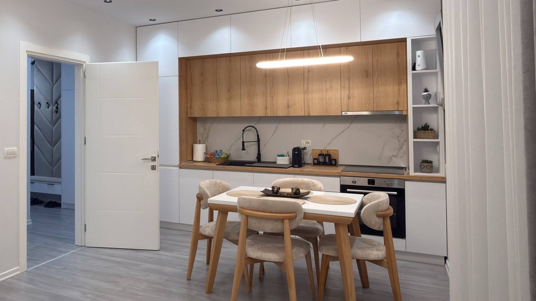 Oak and white kitchen with dining table