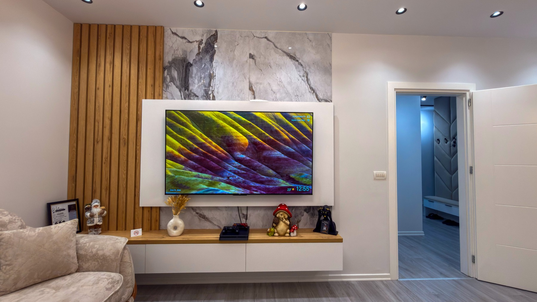 Living room with marble feature wall and warm oak panelling